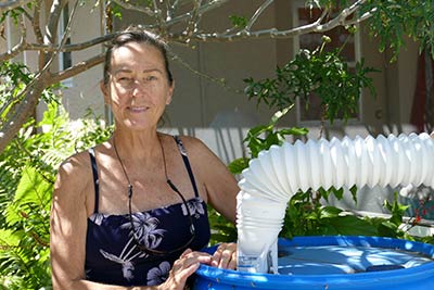 Abbey Calhoun standing by a water tank